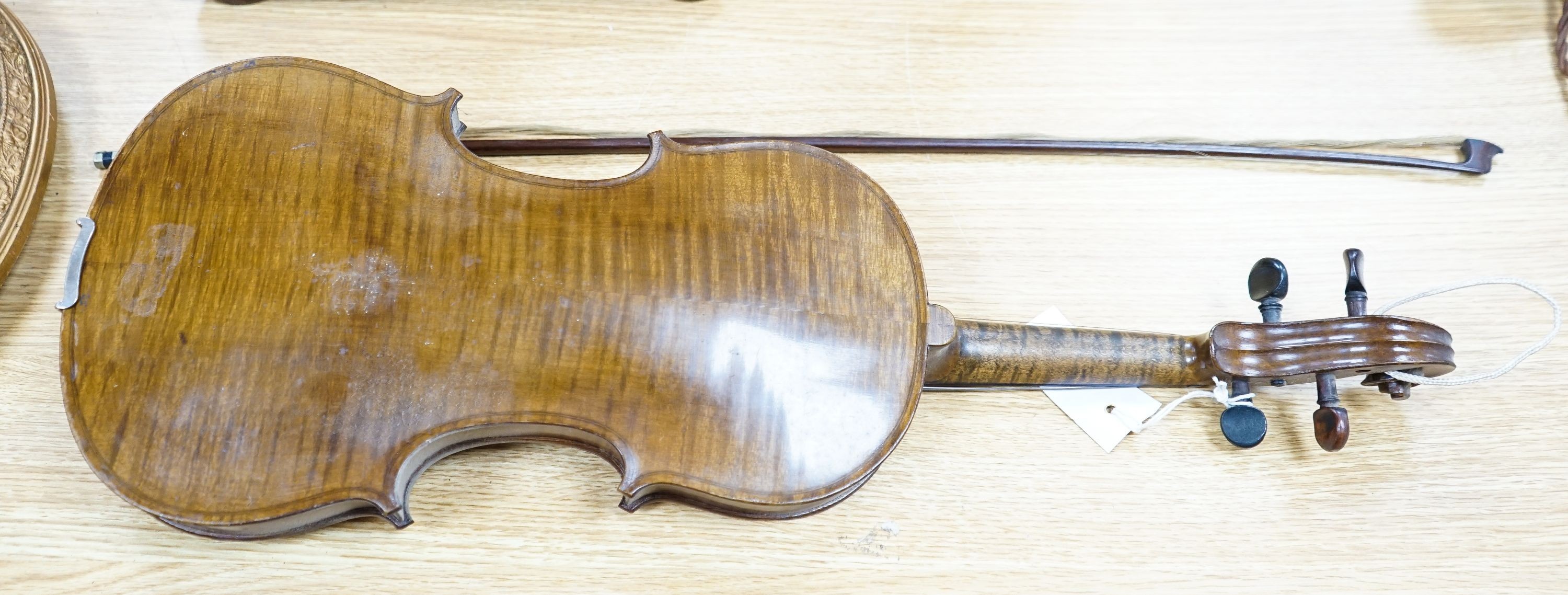 A violin labelled Francesco Ruggeri and a bow. Back of violin excluding button - 36cm